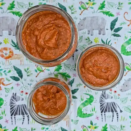 Pureed Roasted Vegetable Tomato Sauce portioned into glass jars ready for fridge storage.