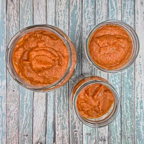 Pureed Ratatouille Pasta Sauce portioned into glass jars ready for fridge storage.