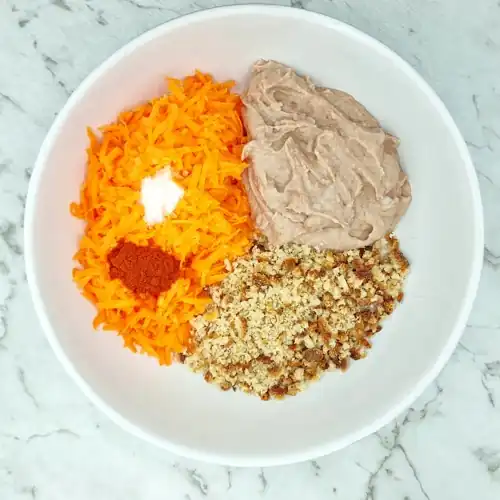 Veggie Nugget ingredient bowl. Pureed mixture of borlotti beans, garlic and onion, grated carrot, breadcrumbs, salt and smoked paprika.